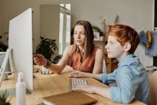 Parent and child sitting at a computer together